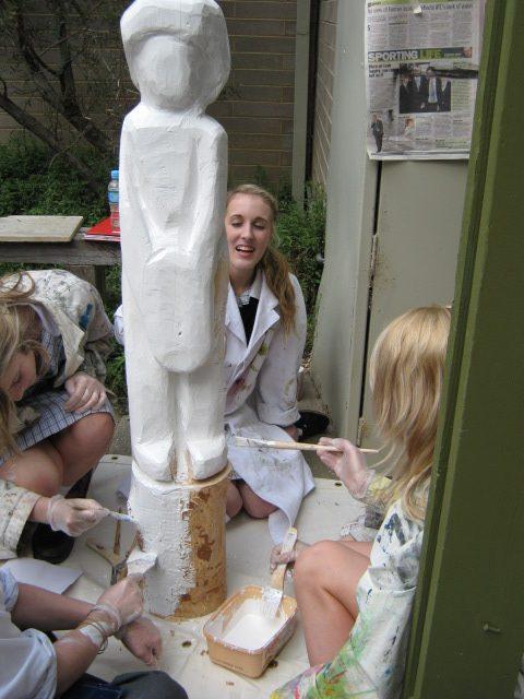 EMILY COLLINS WORKS ON HER SCULPTED LOG